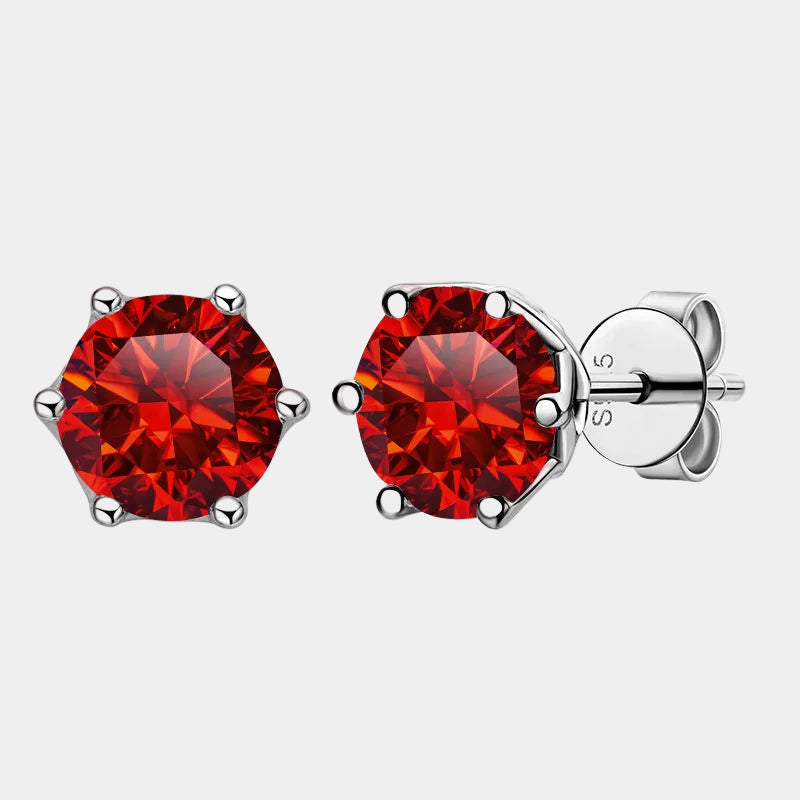 Red gemstone stud earrings on a white background