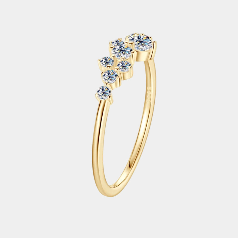 Gold ring with blue gemstones on a white background