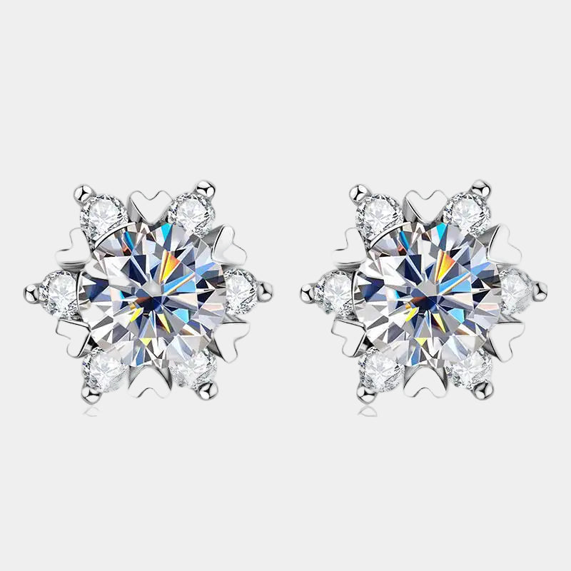 Snowflake-shaped earrings with clear gemstones on a light gray background
