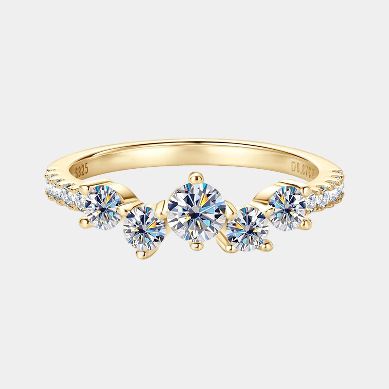 Gold ring with five diamond-like stones on a white background