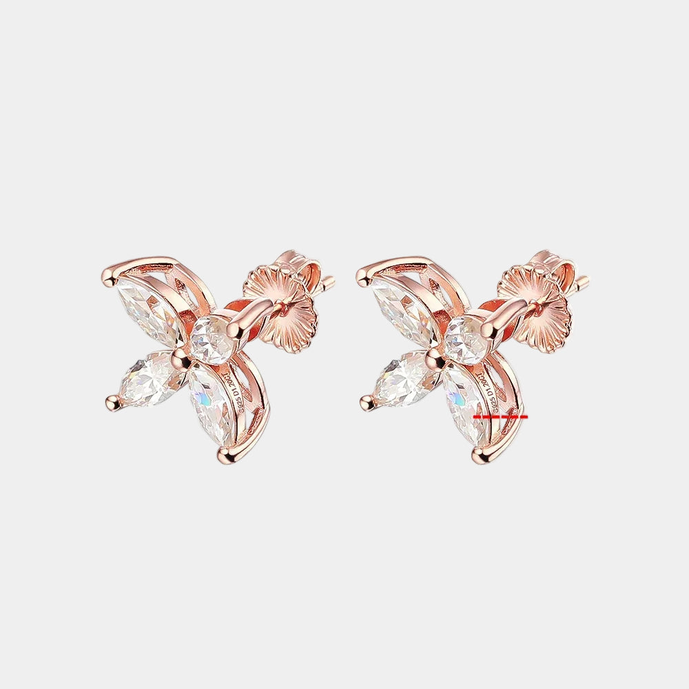 Rose gold butterfly-shaped earrings with moissanite stones on a white background