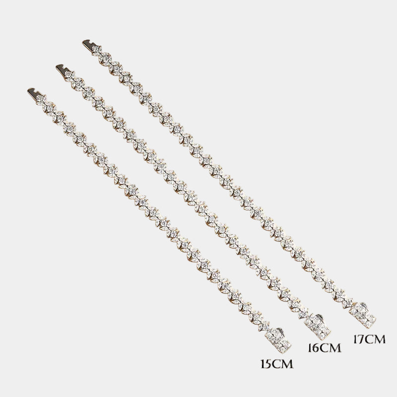Two diamond necklaces of different lengths on a beige background