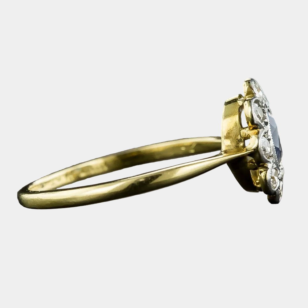 Gold ring with a diamond on a dark background