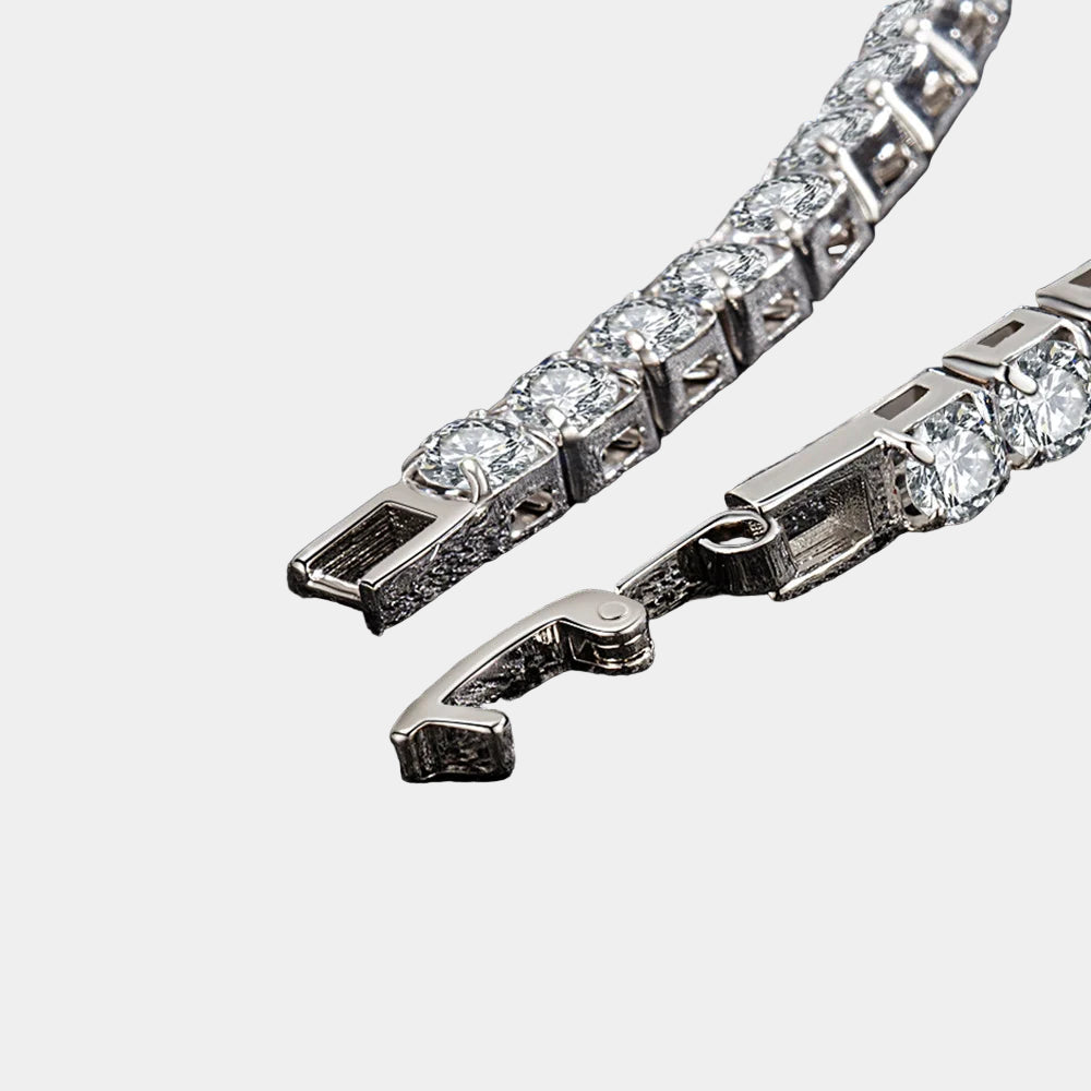 Close-up of a silver bracelet with clear stones on a dark textured background