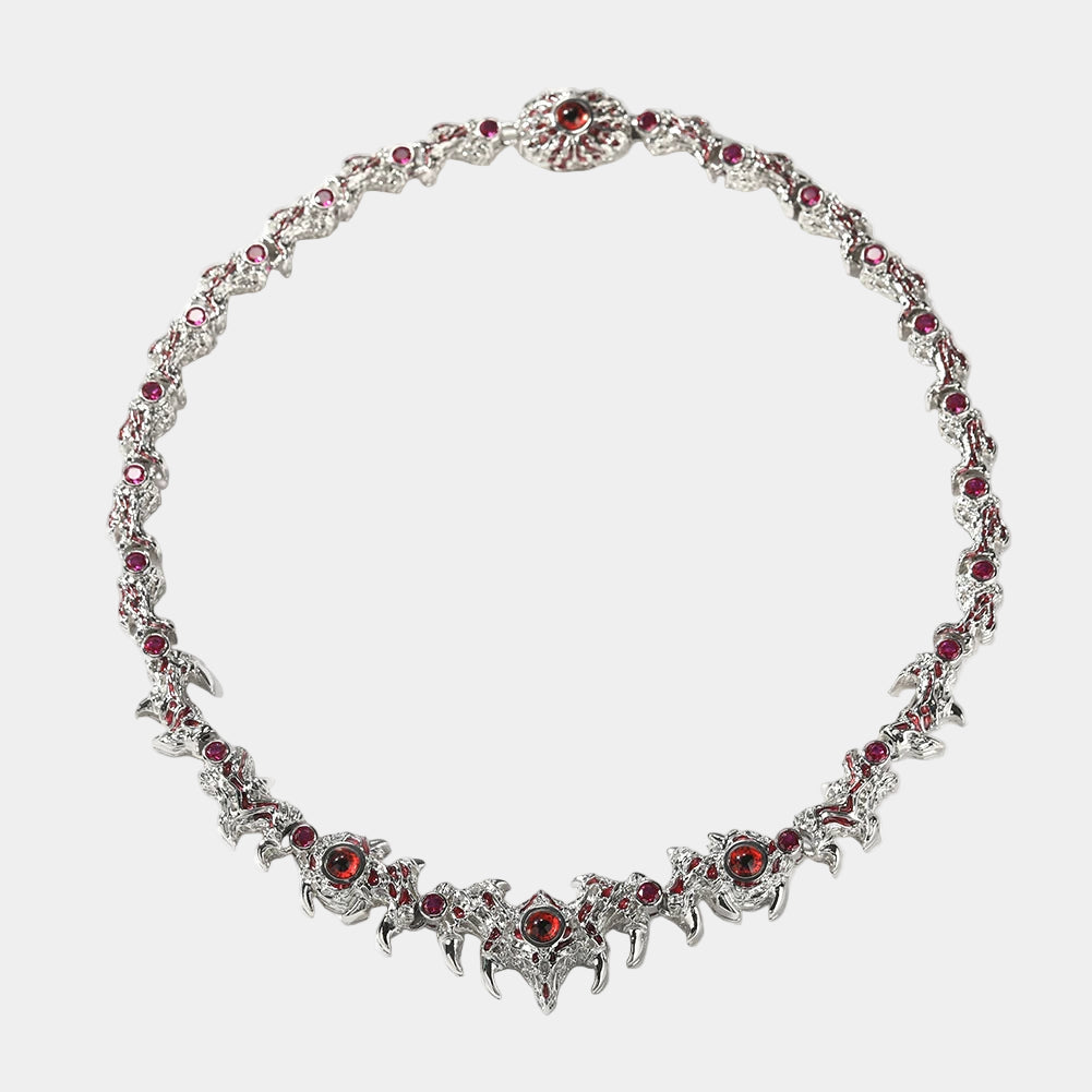 Silver necklace with red gemstones on a white background