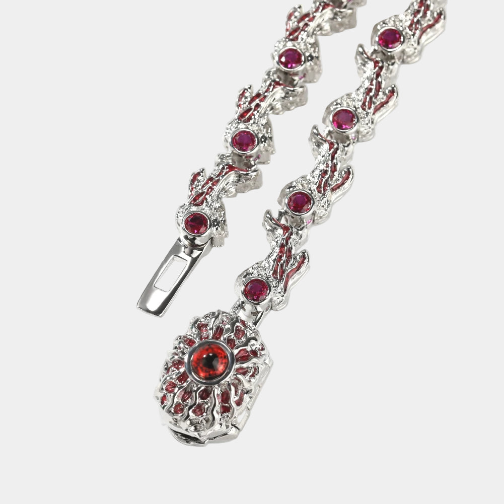 Silver bracelet with red gemstones on a white background